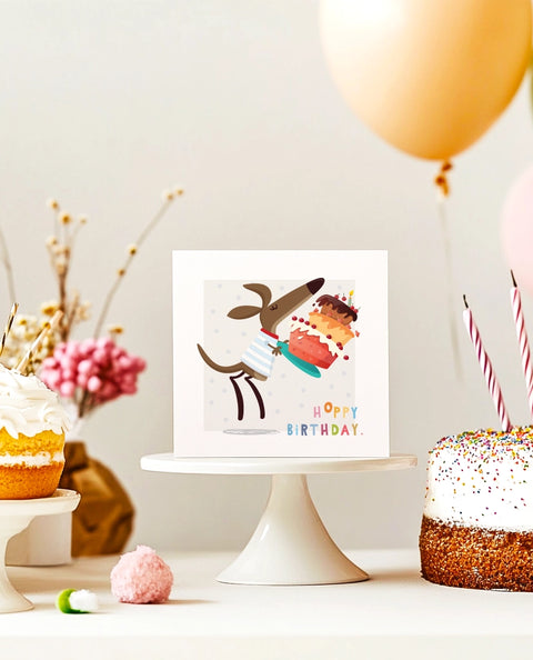 Cute square birthday card featuring a hopping kangaroo with a cake hoppy birthday