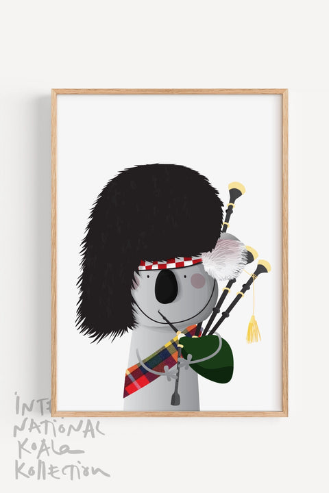 Framed print souvenir for Scots featuring a koala dressed in traditional Scottish attire, playing the bagpipes